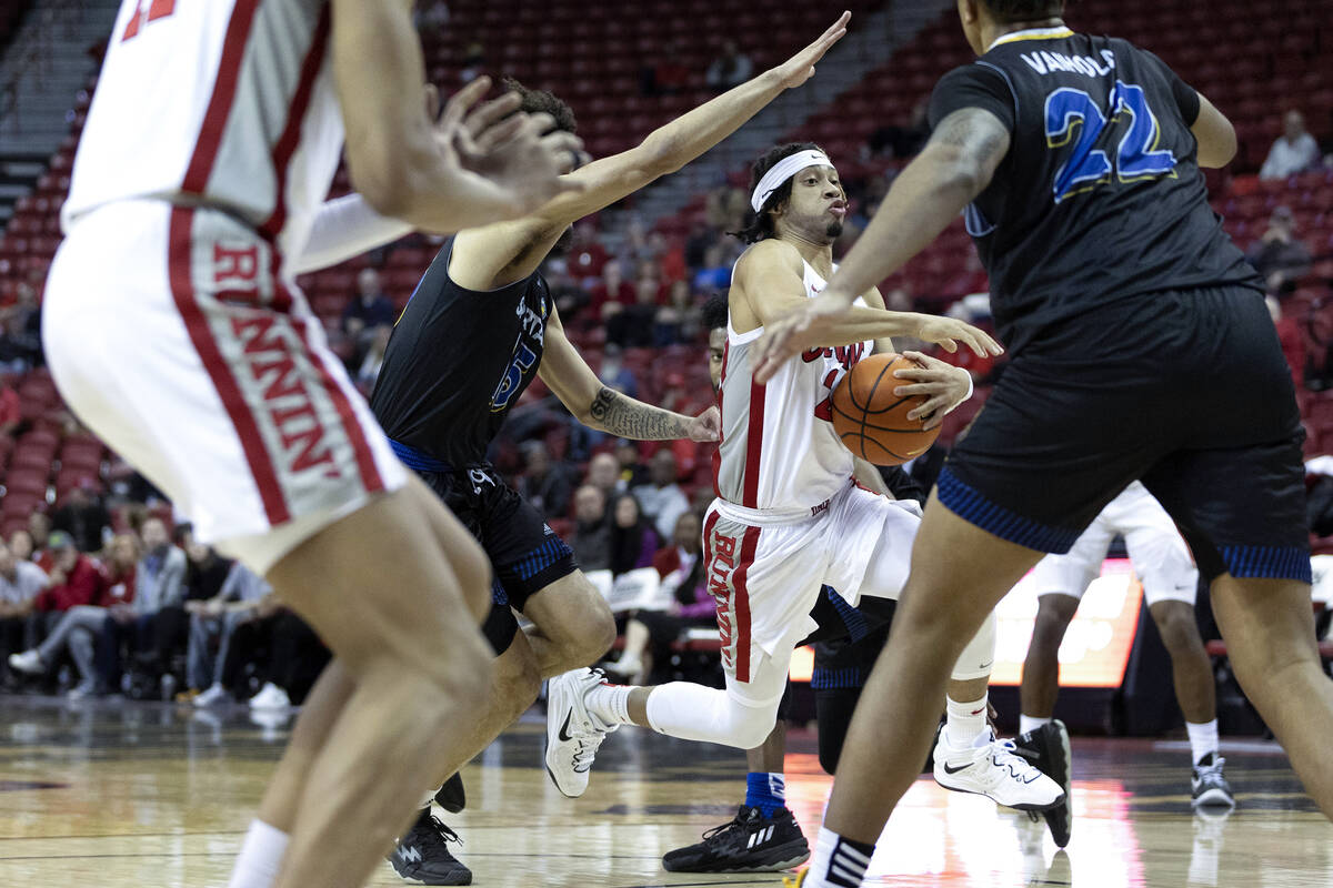 UNLV Rebels guard Justin Webster (2) dribbles toward the hoop while guarded by San Jose State S ...