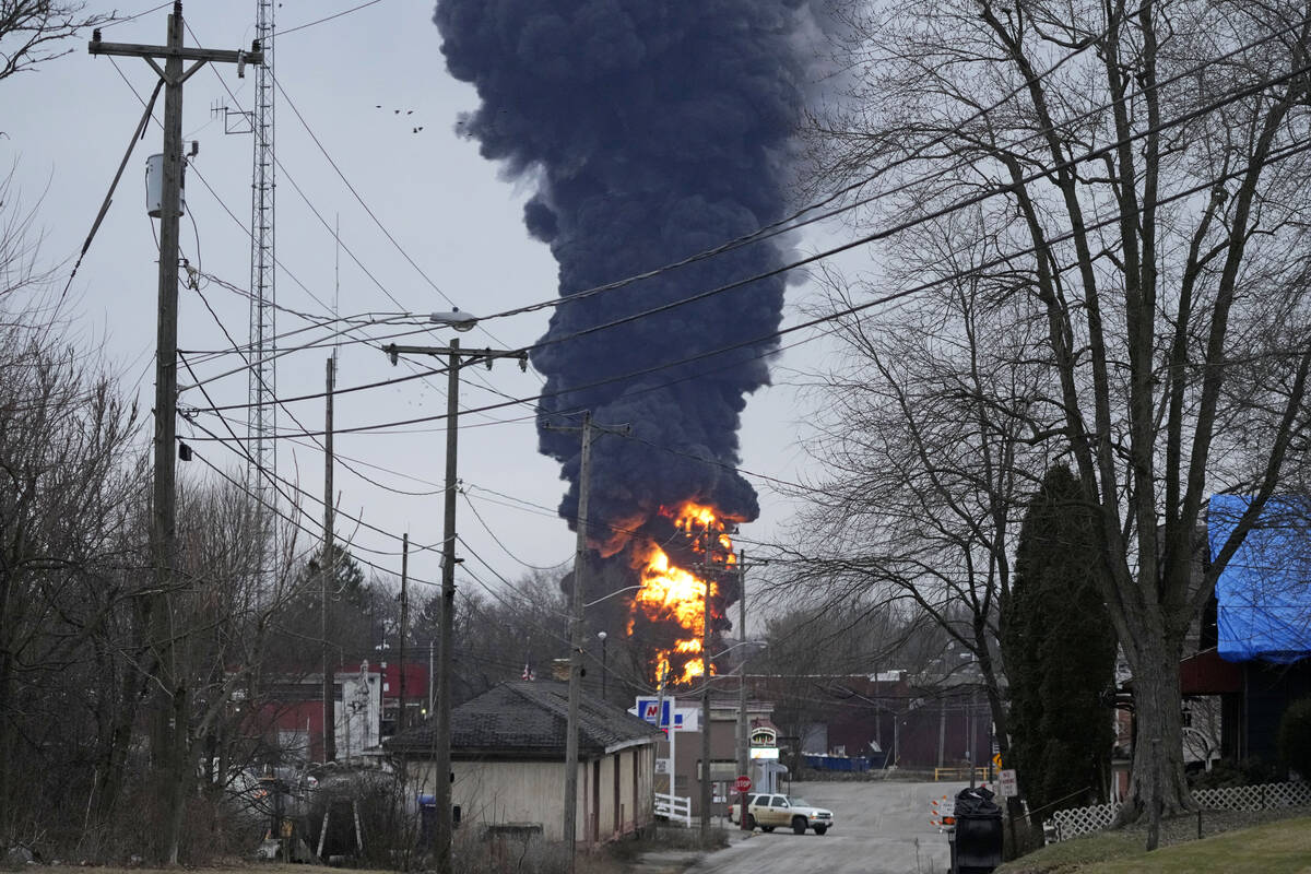 A black plume rises over East Palestine, Ohio, as a result of a controlled detonation of a port ...