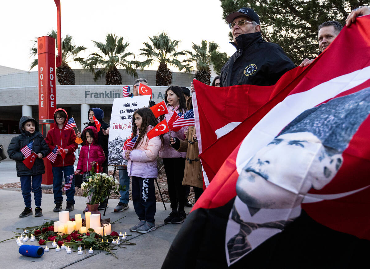 Members of the Turkish community participate in a candlelight vigil to honor and remember the e ...