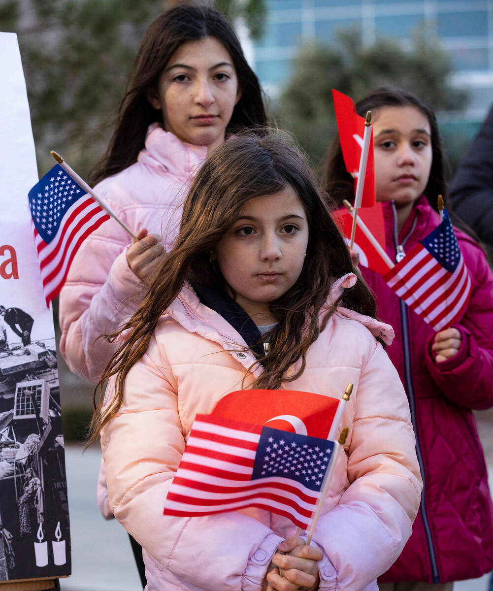Ada Ozdemir, 8, front, Lidya Atici, 9, left, and Neda Cabuk, 11, participate in a candlelight v ...