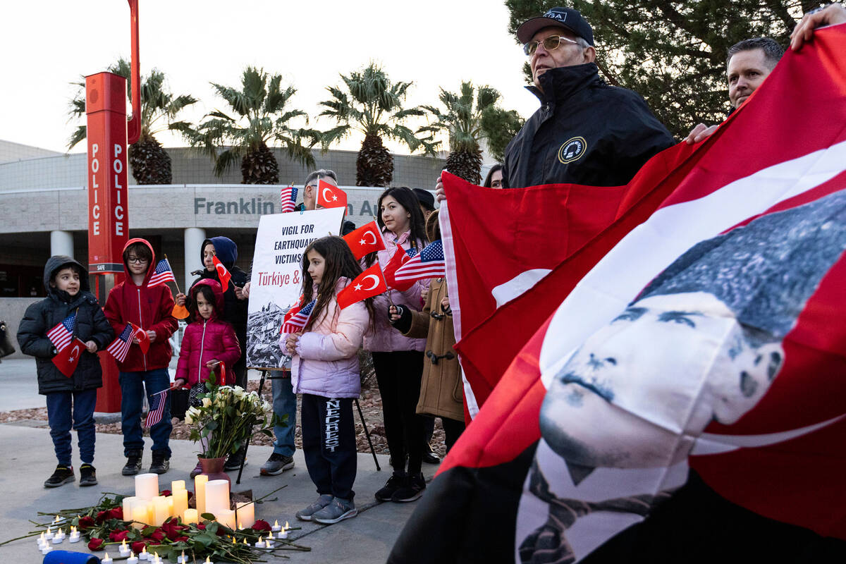 Members of the Turkish community participate in a candlelight vigil to honor and remember the e ...