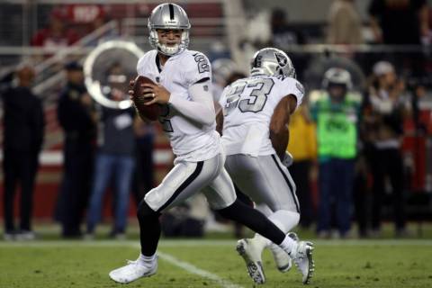 Oakland Raiders quarterback A.J. McCarron (2) rolls out to pass after faking a handoff to runni ...