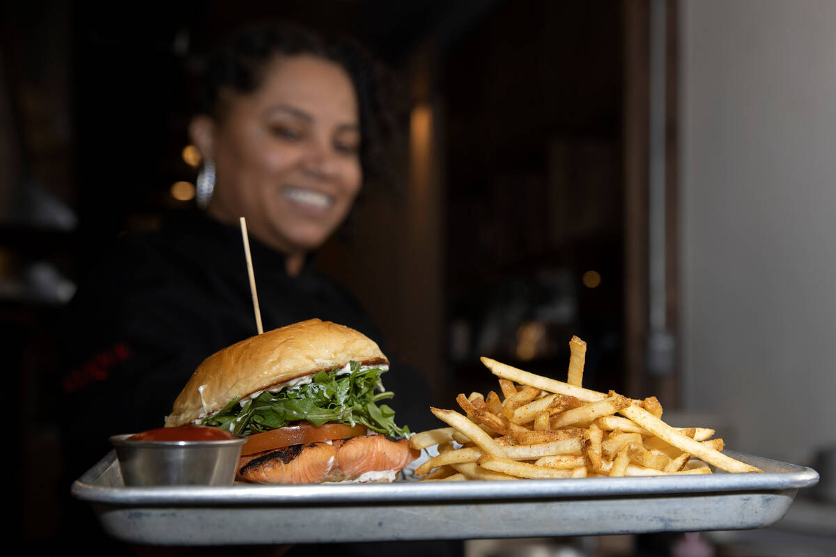 Executive chef Marquita Duren displays Tailgate Social’s salmon sandwich at the restaura ...