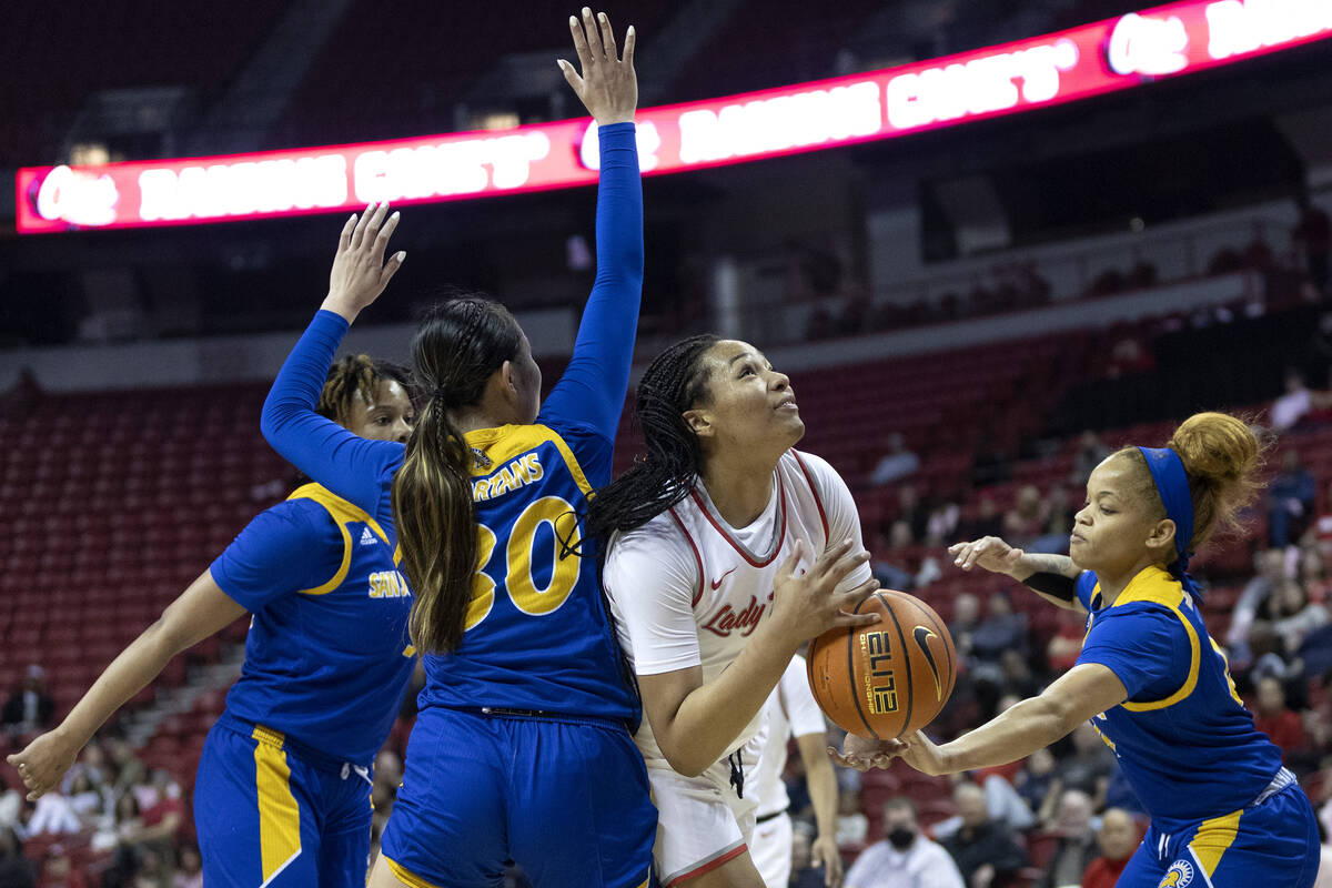 UNLV Lady Rebels forward Alyssa Brown, center right, fights toward the hoop while San José ...