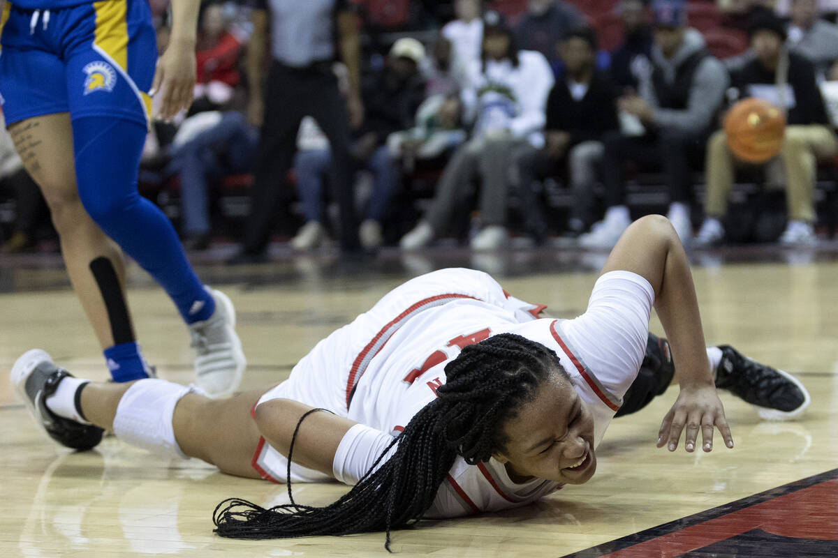 UNLV Lady Rebels forward Alyssa Brown (44) falls to the ground after attempting a layup during ...