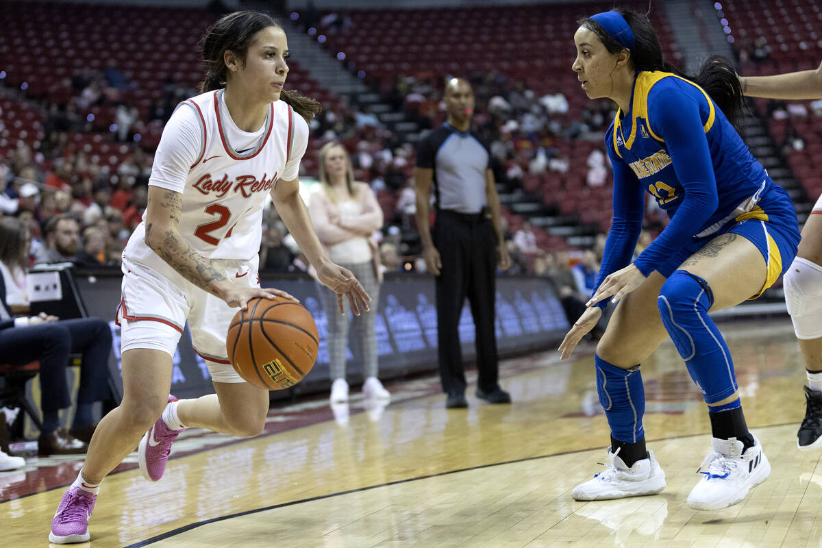 UNLV Lady Rebels guard Essence Booker (24) dribbles around San José State Spartans guard J ...