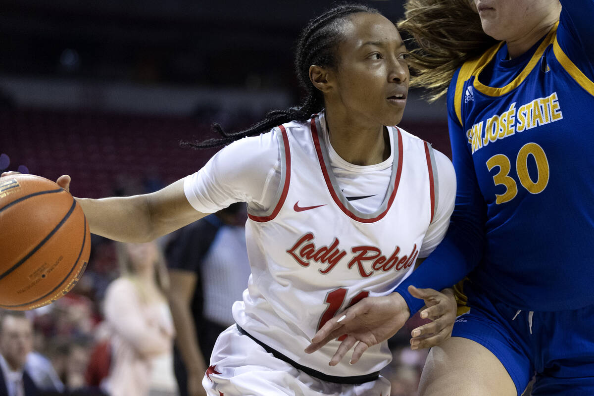 UNLV Lady Rebels guard Justice Ethridge (11) drives around San José State Spartans guard S ...