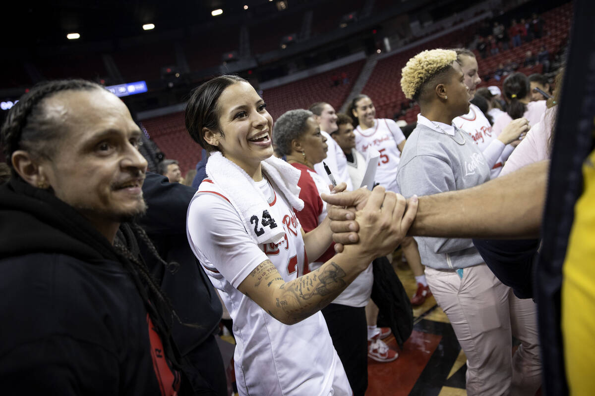 UNLV Lady Rebels guard Essence Booker (24) greets fans after winning an NCAA college basketball ...