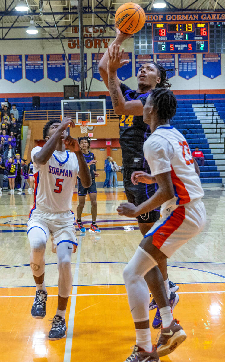 Durango's Taj Degourville (24) elevates over Bishop Gorman's Chris Nwuli (23) land teammate Jax ...