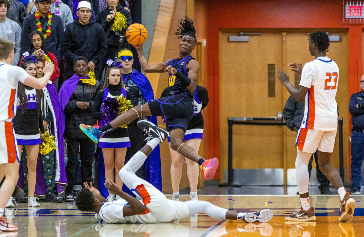 Durango's Tylen Riley (10) leaps out of bounds to save a loose ball as Bishop Gorman's Chris Nw ...