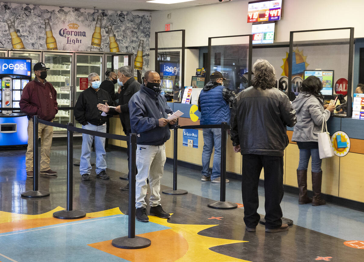 People line up inside The Lotto Store at Primm as they wait to buy Mega Millions and Powerball ...