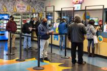 People line up inside The Lotto Store at Primm as they wait to buy Mega Millions and Powerball ...