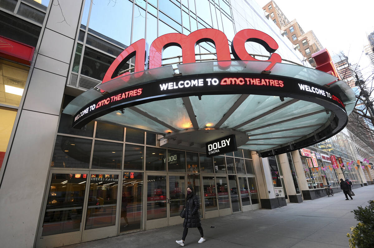A pedestrian walks by the newly reopened AMC 34th Street theater on March 5, 2021, in New York. ...
