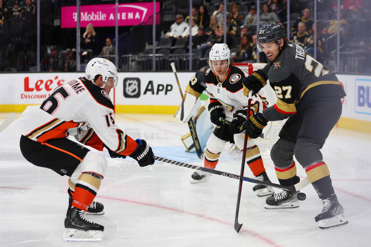 Vegas Golden Knights defenseman Shea Theodore (27) defends against Anaheim Ducks center Ryan St ...