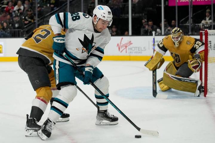 San Jose Sharks right wing Timo Meier (28) attempts to skate around Vegas Golden Knights defens ...