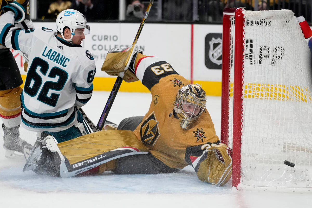 Vegas Golden Knights goaltender Adin Hill (33) dives for the puck during the third period of an ...