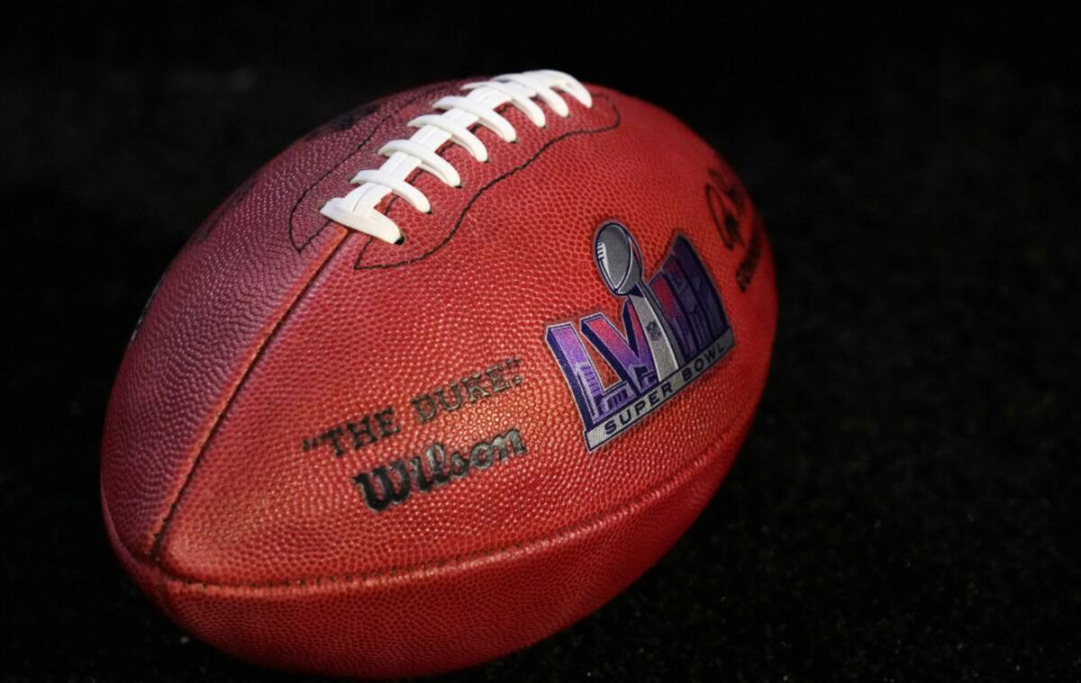 A football with the Super Bowl LVIII logo on it is shown during a news conference in Phoenix on ...