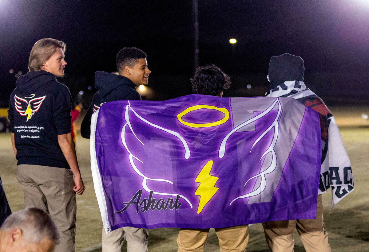 Desert Oasis supporters display a flag in honor of deceased player Ashari Hughes on the sidelin ...