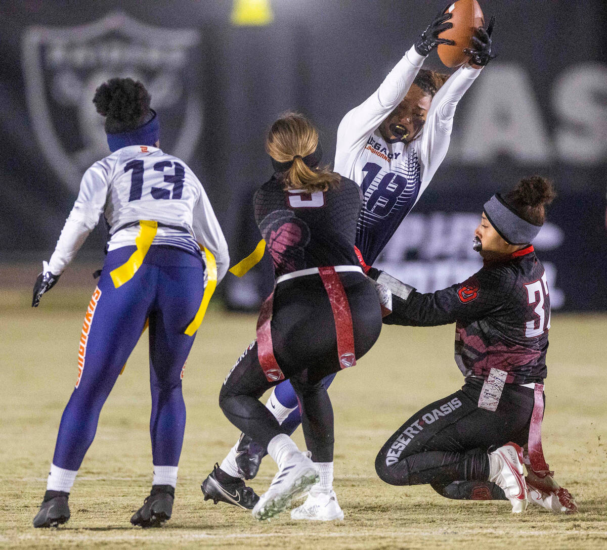 Legacy's Mara Hodges (18) runs after a catch as Desert Oasis' Kaylin DeLespinasse (9) and Devon ...