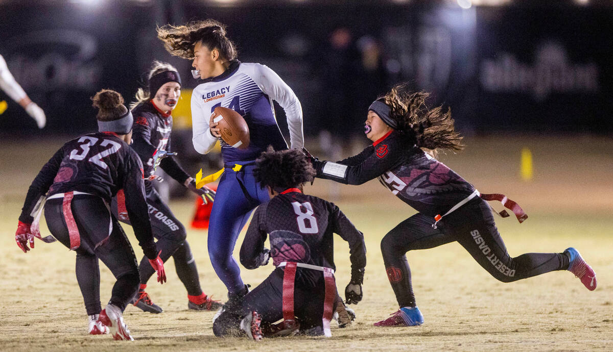 Legacy's Karina Alfaro (14) is swarmed by Desert Oasis players as she attempts to leave the poc ...