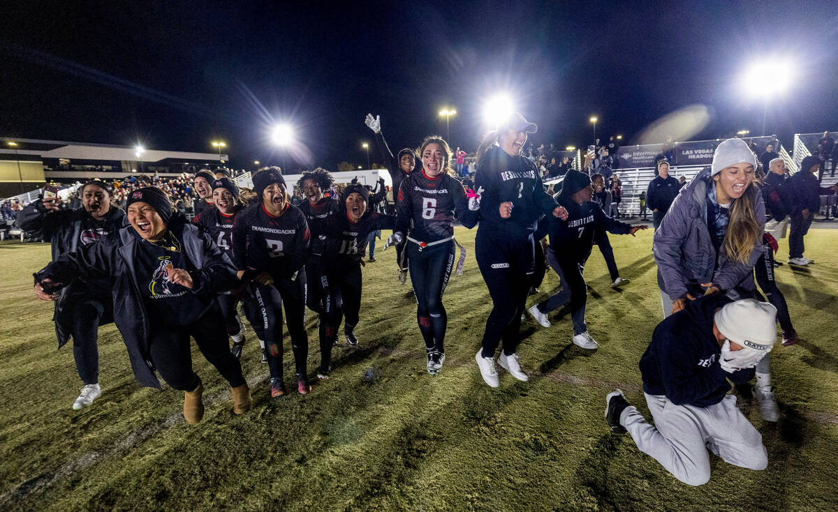 Desert Oasis players begin to celebrate their win over Legacy 28-6 as Head Coach Todd Thomson d ...