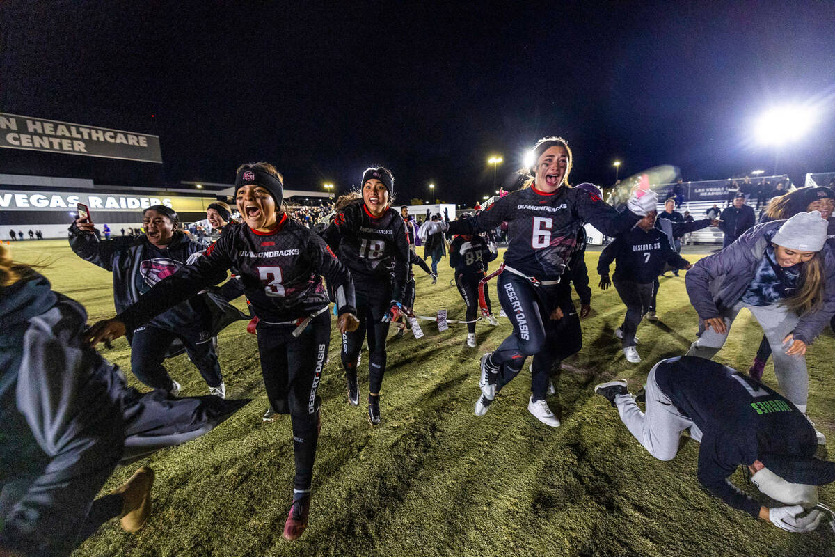 Desert Oasis players begin to celebrate their win over Legacy 28-6 as Head Coach Todd Thomson d ...