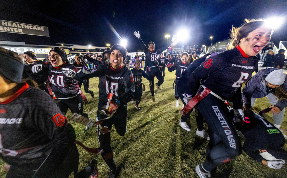 Desert Oasis players celebrate their win over Legacy 28-6 as Head Coach Todd Thomson drops to h ...