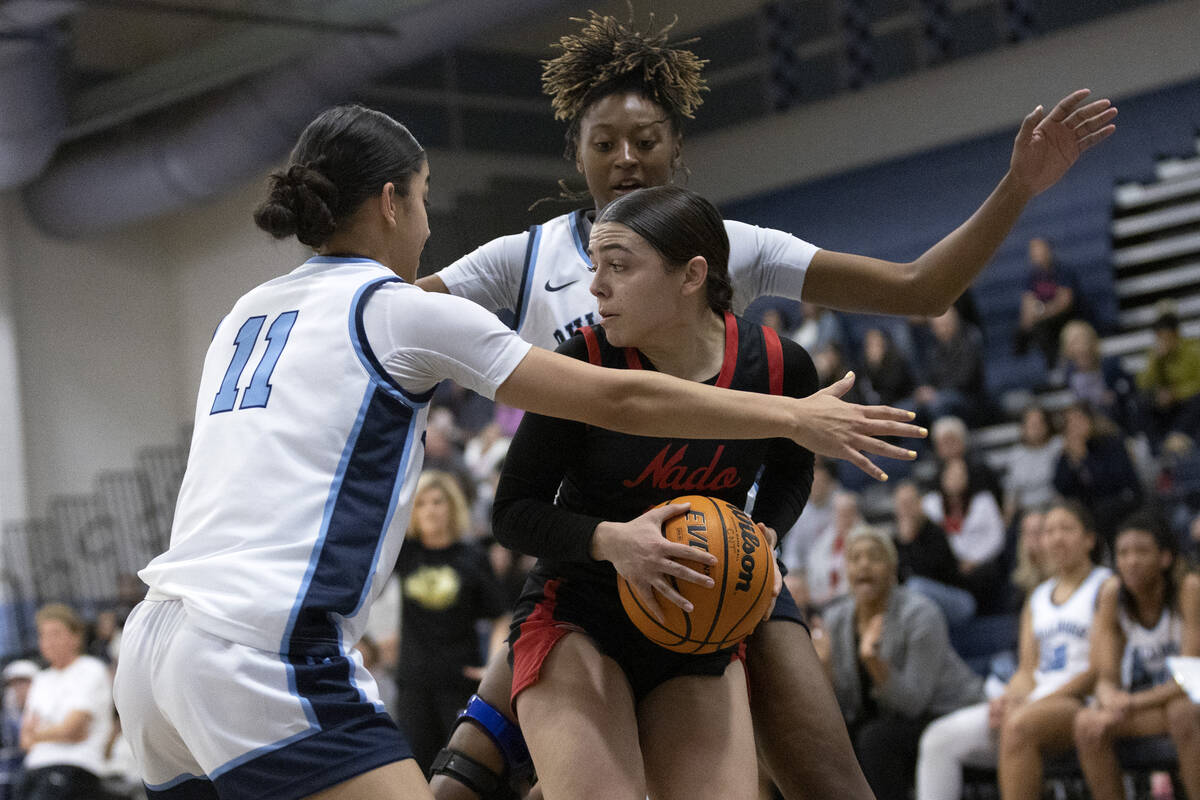 Coronado’s Kaylee Walters (14) is surrounded by Centennial’s Danae Powell (11) an ...