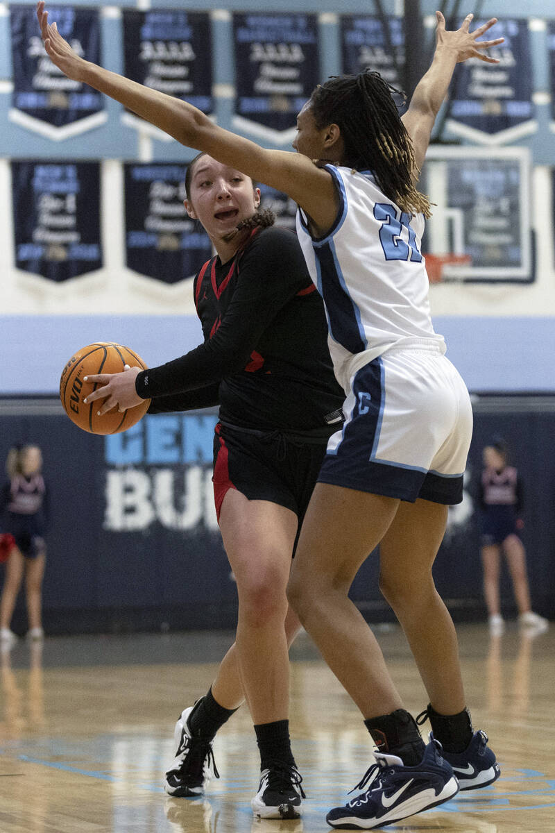 Coronado’s Ashtyn Wick (22) attempts to pass around Centennial’s CiCi Ajomale (21) during a ...