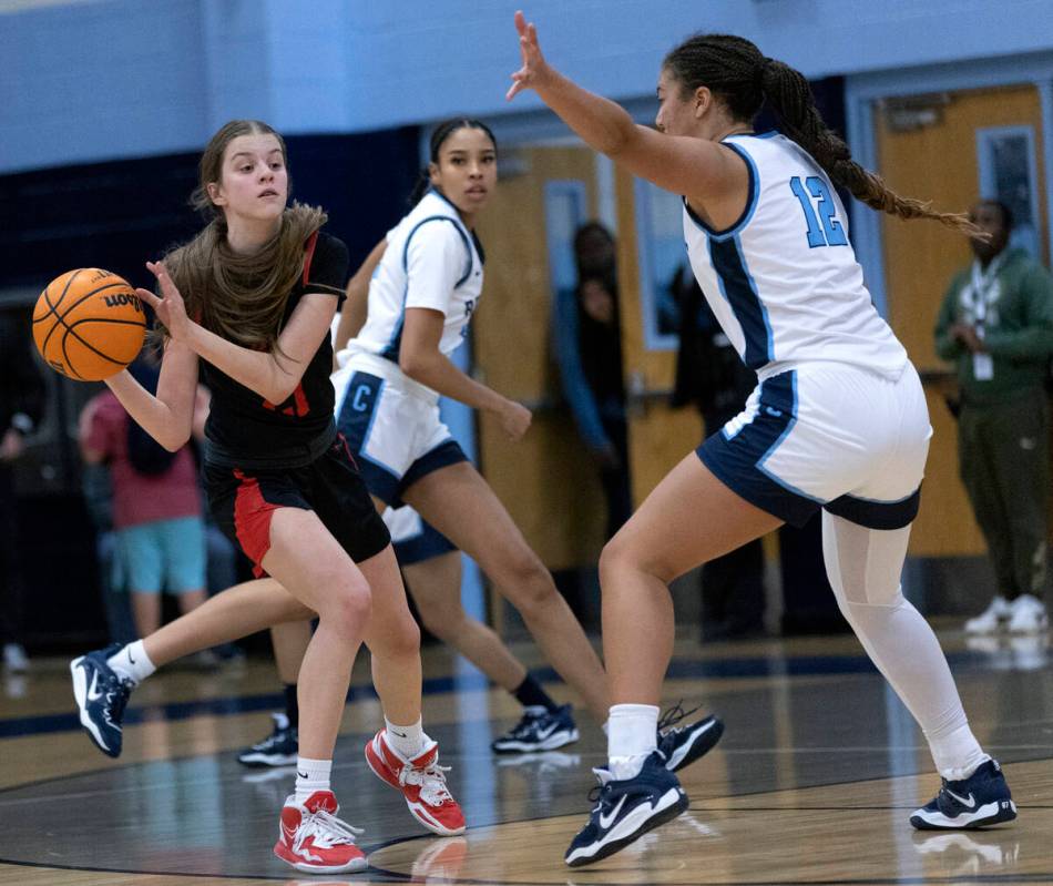 Coronado’s Ella Creer passes while Centennial’s Ayla Wiliiams (12) guards her dur ...