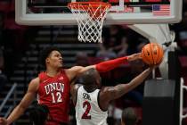 San Diego State guard Adam Seiko (2) shoots as UNLV center David Muoka (12) defends during the ...