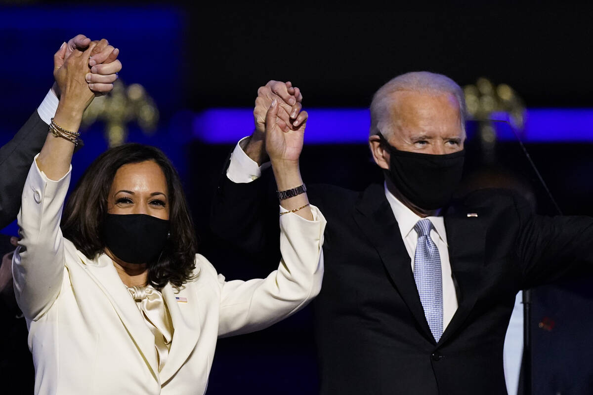 In this Nov. 7, 2020, file photo Vice President-elect Kamala Harris holds hands with President- ...