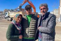 Taha Erdem, 17, center, his mother Zeliha Erdem, left, and father Ali Erdem pose for a photogra ...