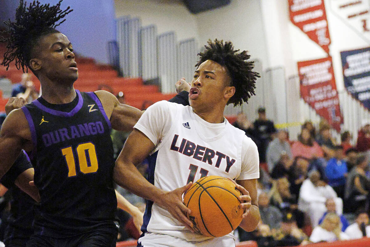 Liberty's Dedan Thomas (11) looks to pass against Durango's Tylen Riley (10) during the first h ...