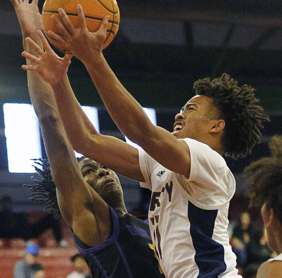 Liberty's Dedan Thomas (11) attempts a jump shot as Durango's Tylen Riley (10) defends during t ...
