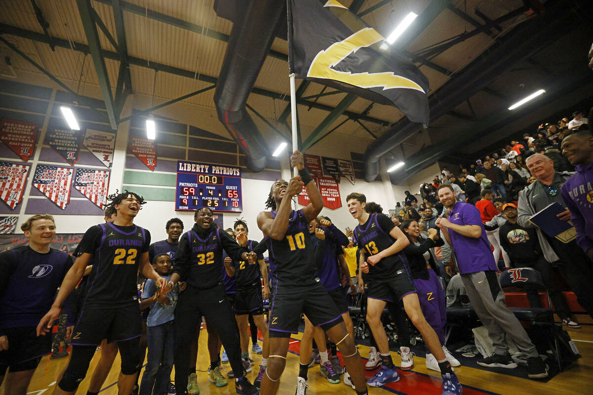 Durango High School players celebrate their 65-59 victory against Liberty High School after the ...