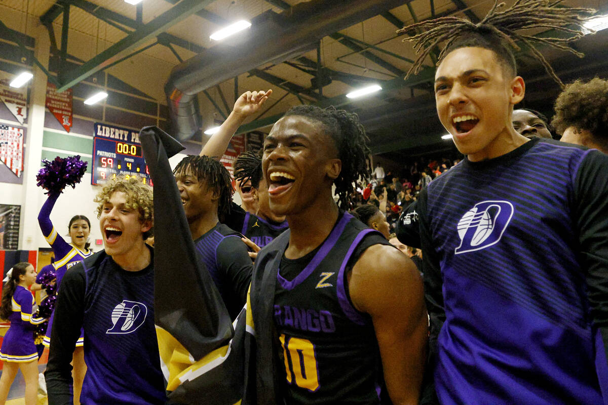 Durango High School players including Tylen Riley (10) celebrate their 65-59 victory against Li ...