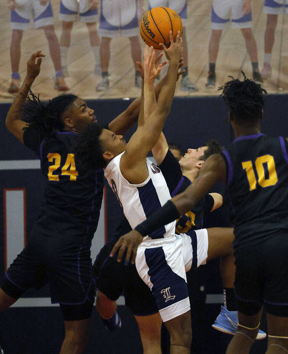 Liberty's Dedan Thomas (11), Durango's Taj Degourville (24) and Durango's Colton Knoll (13), be ...