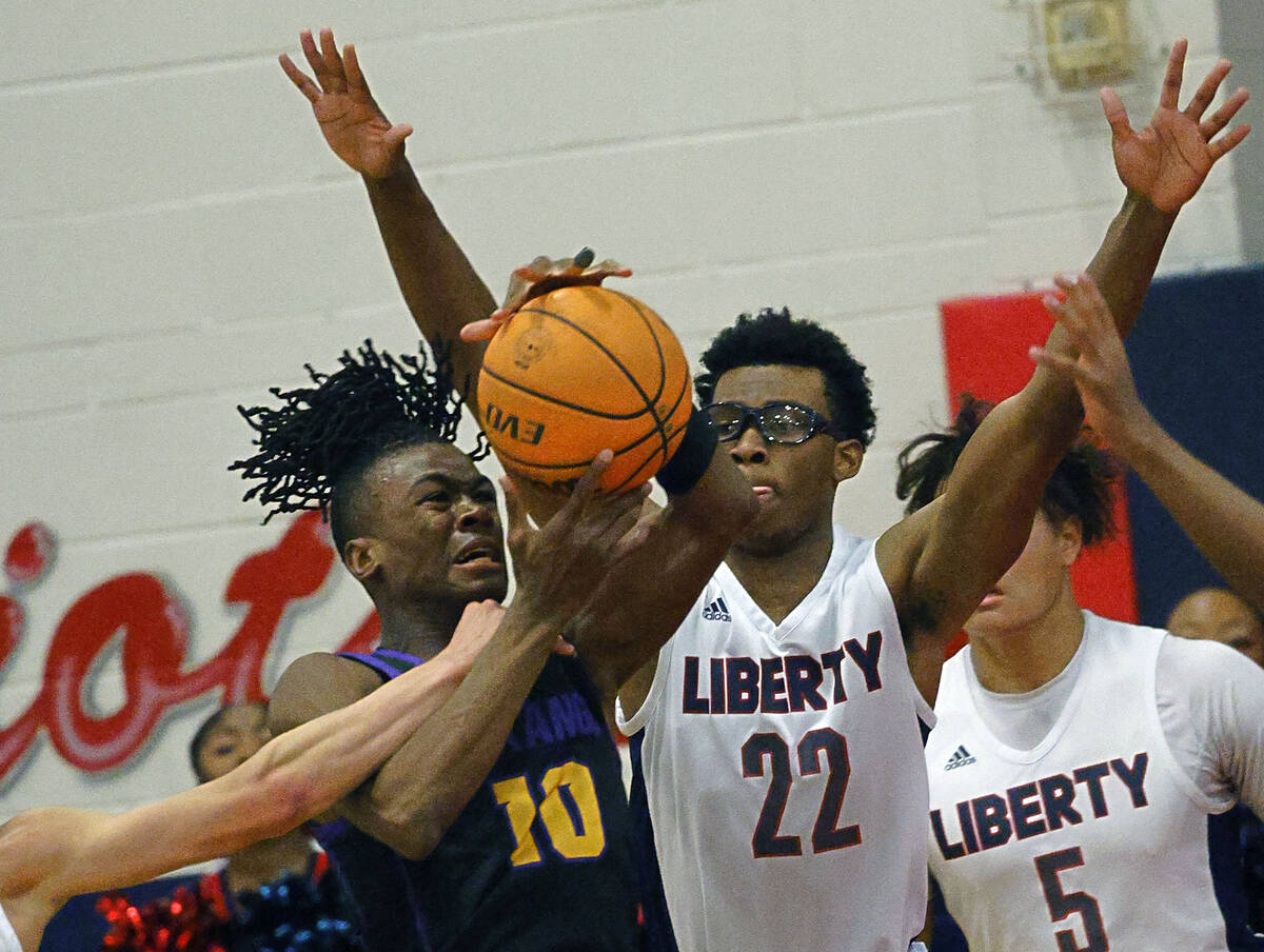 Durango's Tylen Riley (10) looks to pass against Liberty's Javares Reid (22) during the first h ...