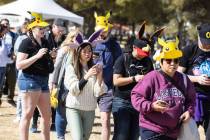 Participants at Pokémon Go Tour: Hoenn – Las Vegas navigate Sunset Park while play ...