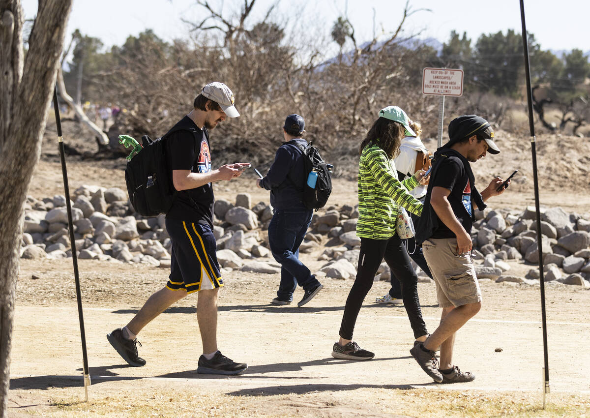 Participants at Pokémon Go Tour: Hoenn – Las Vegas navigate Sunset Park while play ...