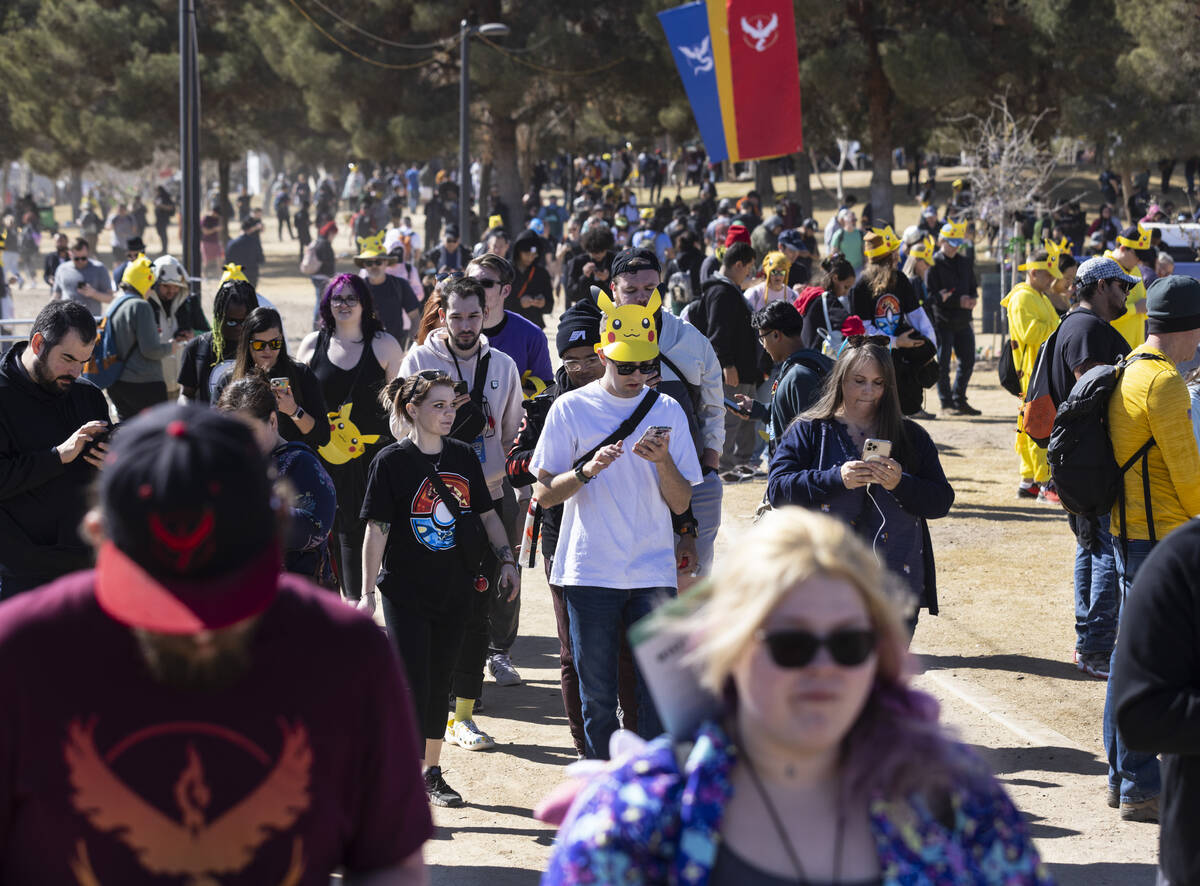 Participants at Pokémon Go Tour: Hoenn – Las Vegas navigate Sunset Park while play ...