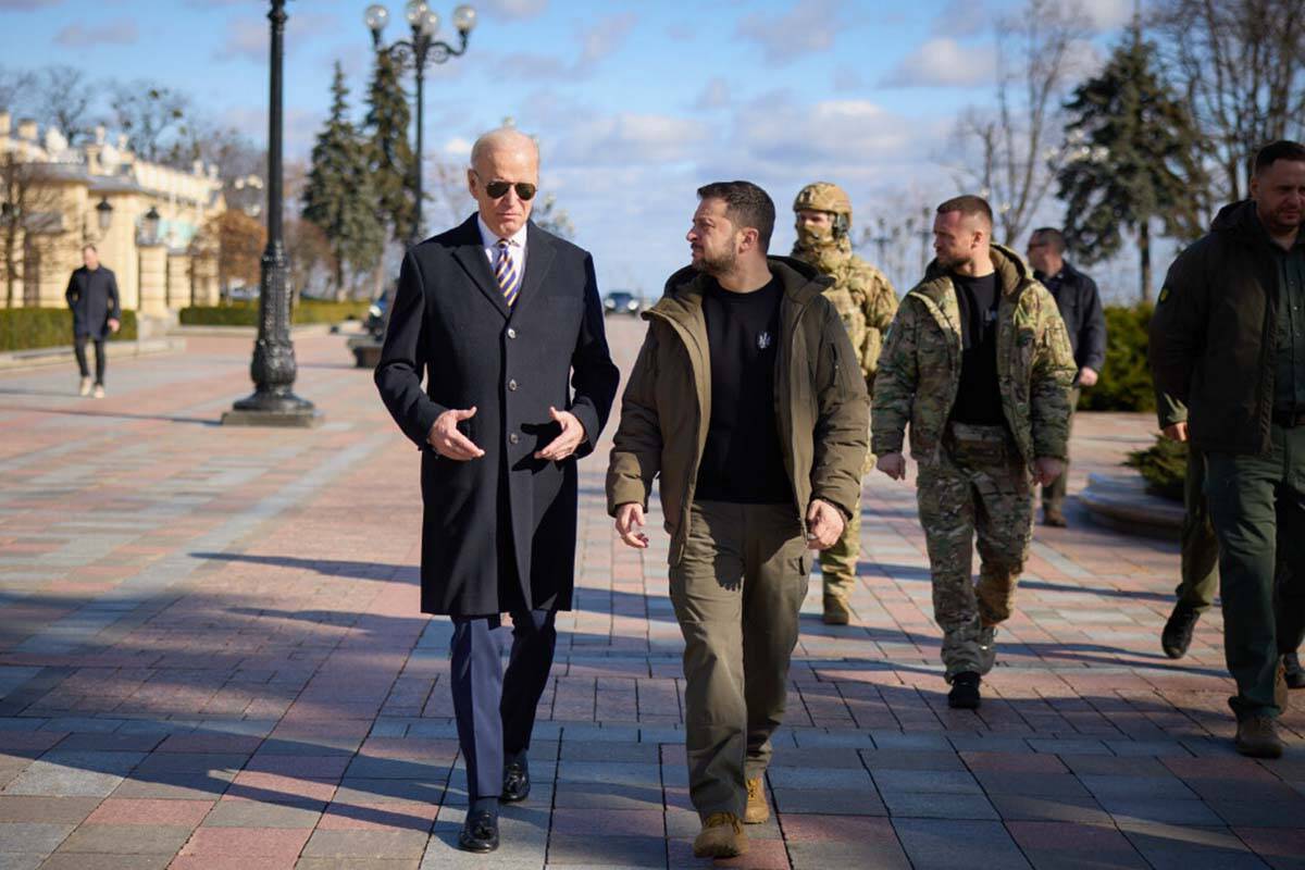 US President Joe Biden, left, and Ukrainian President Volodymyr Zelenskyy walk during an unanno ...