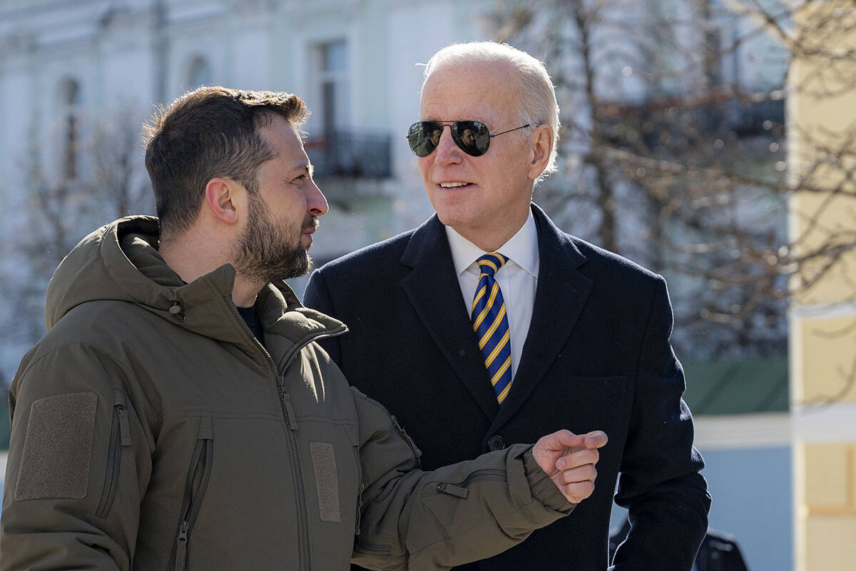 President Joe Biden, right, and Ukrainian President Volodymyr Zelenskyy talk during an unannoun ...