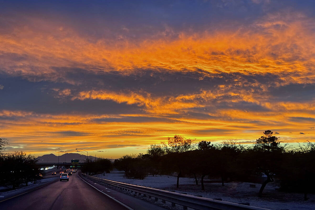 The sky explodes in color as the sun rises in the east adjacent to the Summerlin Parkway on Wed ...