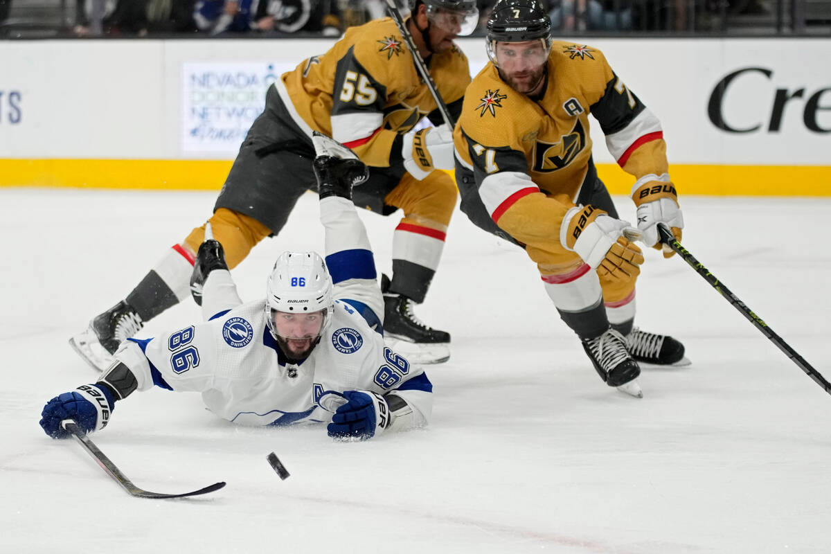Tampa Bay Lightning right wing Nikita Kucherov (86) attempts to knock the puck up the ice again ...