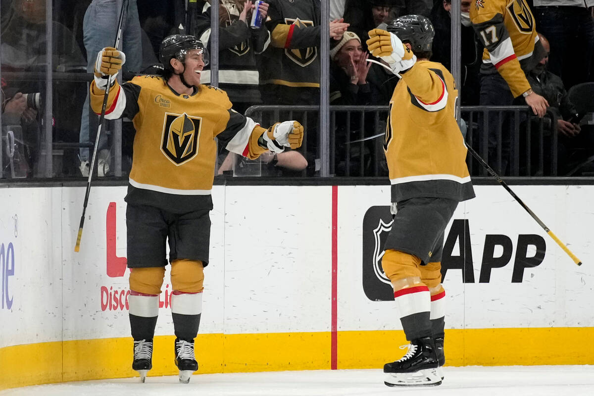Vegas Golden Knights right wing Jonathan Marchessault, left, celebrates after scoring against t ...