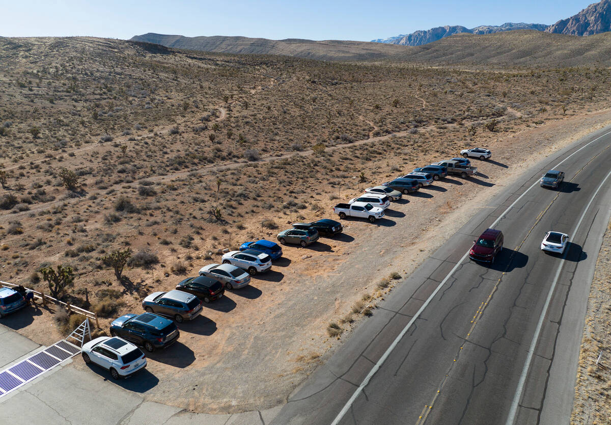 Tourists park their cars along State Route 159 to visit the Red Rock Canyon National Conservati ...