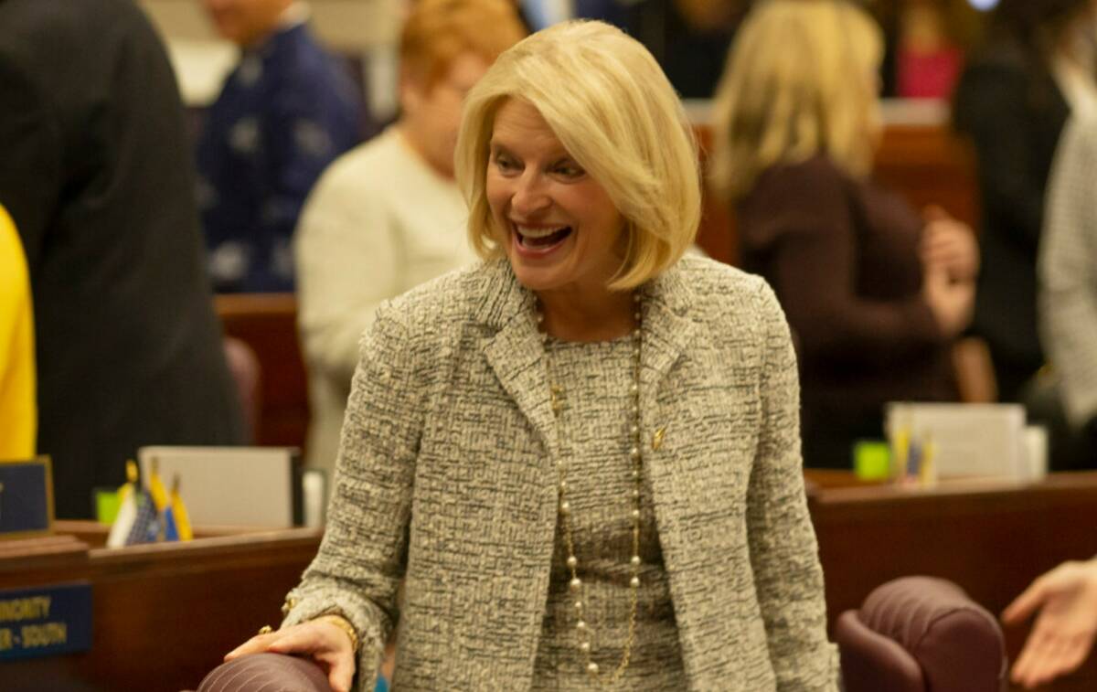 Assemblywoman Heidi Kasama, R-Las Vegas, laughs with lawmakers during the opening of the 82nd S ...