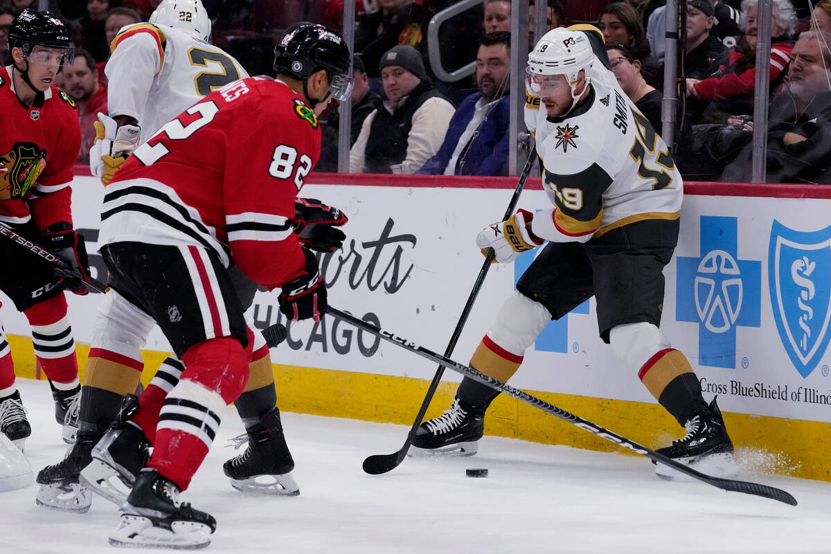 Vegas Golden Knights right wing Reilly Smith, right, controls the puck against Chicago Blackhaw ...